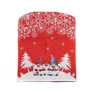 Christmas chair cover featuring red fabric with white snowflakes and three festive gnomes