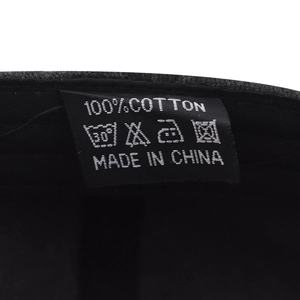 Detail view of the 100% cotton wash label and quality stitching inside the baseball cap
