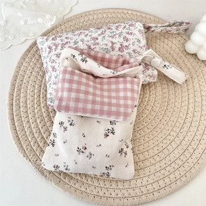 Detail view of floral fabric nurse pocket protector pouches with cute snap button closure