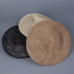 Close-up of hollow knit beret hats in black, beige and khaki with breathable mesh texture