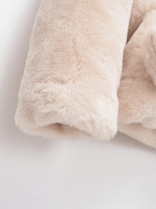 Close-up of the soft off-white plush faux fur texture and high-density fabric detail