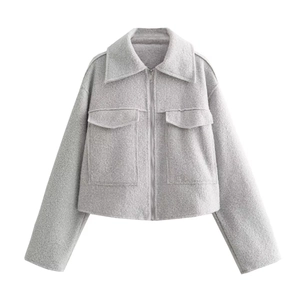 Close-up of grey wool blend cropped jacket featuring large flap pockets and metal zipper