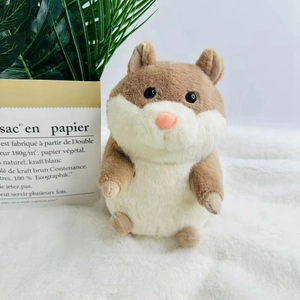 Cute brown and white stuffed guinea pig plush toy sitting on a soft white carpet rug