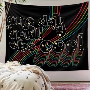 Detail of bohemian rainbow tapestry with 'one day you'll be cool' text on black background