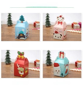 Detail view of four Christmas gift boxes with penguin, bear, reindeer and Santa designs