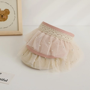 Detail of kids straw sun hats featuring elegant white lace, mesh veils, and pearl accents