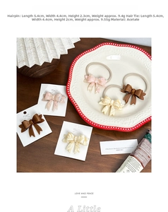 Detail of cellulose acetate bow hair clip and scrunchie on elegant wooden setup
