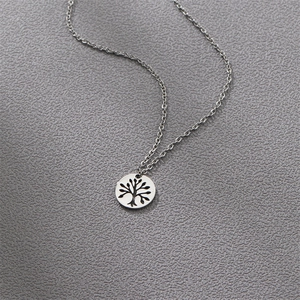 Macro shot of silver stainless steel tree of life pendant on fine O-chain necklace
