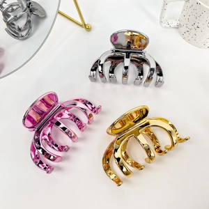 Three large metal hair claw clips in silver, gold, and pink colors for thick hair