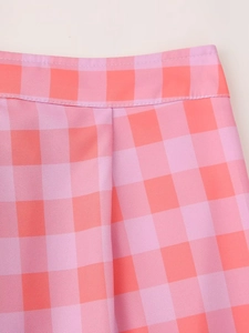 Detail of pink and orange plaid skirt waist with clean stitching and woven texture