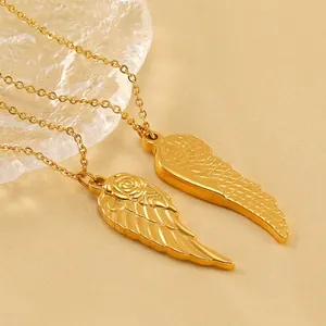 Elegant 18K gold rose angel wing pendant necklaces on a luxury display tray