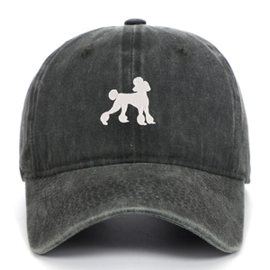 Close-up of embroidered white poodle motif on washed dark gray cotton baseball cap