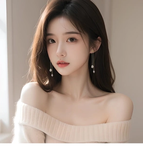 Detail of s925 silver long tassel earrings with natural freshwater pearls worn by model