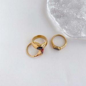 Close-up of vintage gold signet rings set with dark red and black oval gemstones