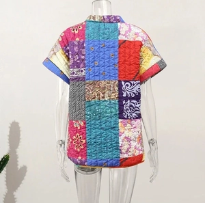 Detailed back view of a sleeveless quilted vest featuring colorful patchwork floral patterns