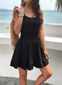 Detail of elegant black strapless mini dress featuring a smocked waist for a beach vacation