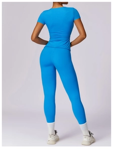 Rear view of electric blue tight-fitting yoga short sleeve and high waist leggings