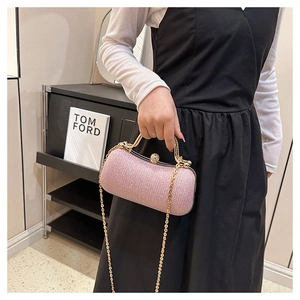 Detail of pink sequin clutch evening bag featuring gold handle and crystal clasp