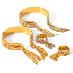 Golden and bicolor stainless steel cuff bracelets and rings with beaded tassel details