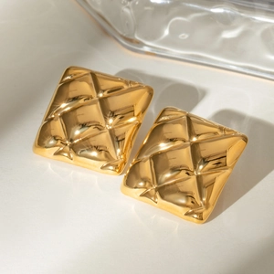 18k gold plated stainless steel square quilted earrings on textured glass backdrop