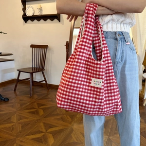 Detailed view of red and white gingham plaid tote bag with sozakka beaute fabric label