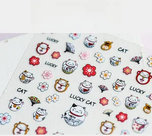 Close-up of 5D thin adhesive nail stickers with lucky cat and cherry blossom patterns