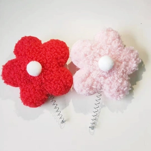 Detail of red and pink plush flower spring accessories with soft fuzzy texture