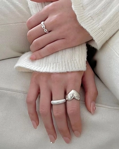 Three minimalist 925 sterling silver rings including a puffy heart and textured bands