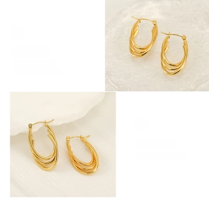 Detailed close-up of multilayer gold plated stainless steel hoops with polished finish