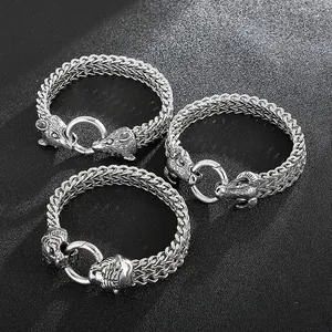 Detailed view of silver braided chain bracelets featuring wolf, tiger and goat heads