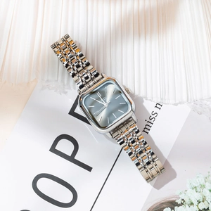 Detail of silver square case watch with grey sunray dial and multi-link metal strap