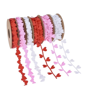 Detail of red and pink heart printed ribbons in rolls for wedding gift wrapping