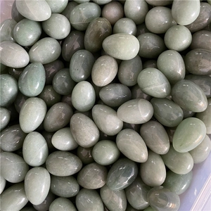 Macro shot of polished green natural jade egg stones for Easter and fitness use