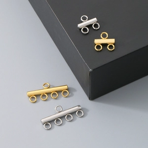 Detail view of gold and silver multi-hole stainless steel connectors for DIY jewelry