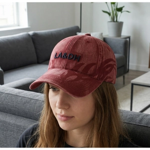 Macro detail of vintage washed burgundy baseball cap with black 3D LA&DH embroidery