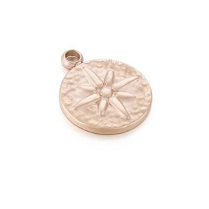 Macro shot of rose gold star embossed pendant with hammered texture and metal ring