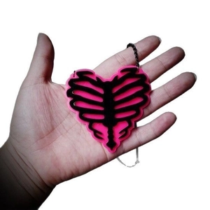 Pink heart-shaped rib cage acrylic pendant necklace with a black chain for women