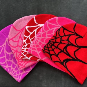 Knit beanie hat featuring spider web jacquard pattern in various vibrant colors