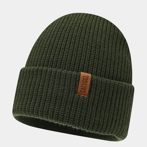 Detailed view of dark green ribbed knit beanie featuring a brown leather logo patch