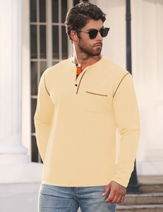 Detail of light yellow men's Henley shirt with three-button neckline and orange stitching