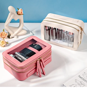 Dual-layer travel toiletry bags with clear top and golden zippers in pink and beige