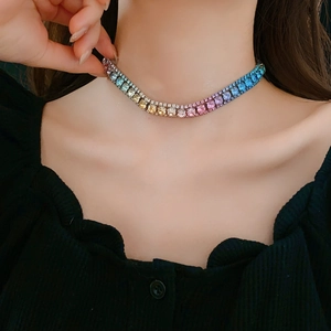Detail view of a luxury gradient rainbow rhinestone choker necklace on a model's neck