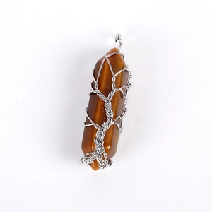 Detail of tiger eye hexagonal prism pendant wrapped in silver wire tree of life design
