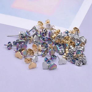 Detail view of heart-shaped stainless steel earrings with textured finish in multiple colors