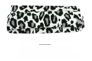 Close-up of double-layer leopard print knit beanie showing warm lining and thick texture