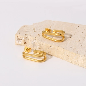 18k gold plated double-layer oval hoop earrings on beige travertine stone display