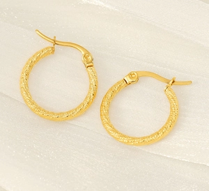 Close-up of gold plated stainless steel hoop earrings with elegant twisted rope texture