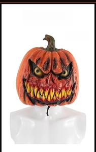 Front view of scary Halloween pumpkin mask with orange rot texture and sharp yellow teeth