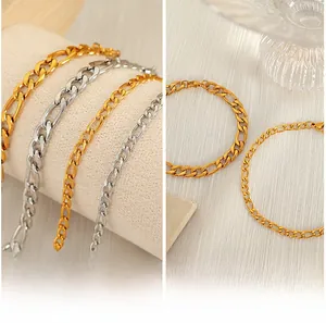 Detail of Figaro chain links in gold and silver finish with high polished metal texture