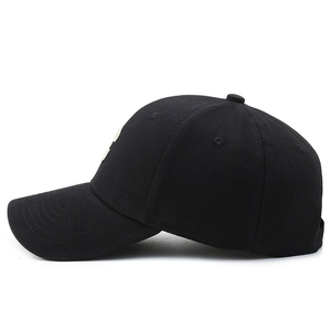 Classic black cotton twill baseball cap with curved brim shown in a professional side view